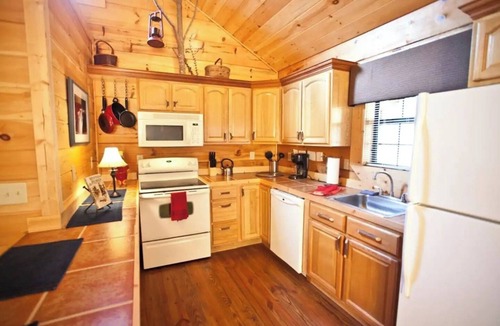 Tellico Plains Cabin | Cowboy cabin. Modern log cabin spacious studio with HOT TUB that will take you back in time.