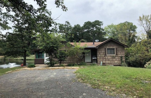 Collinsville House | Escape to a private 3BR waterfront retreat on a 7-acre pond near Route 66. Enjoy peaceful views, a fire pit with seating, fishing dock, and spacious living areas. Perfect for relaxing getaways with easy access to St. Louis attractions.