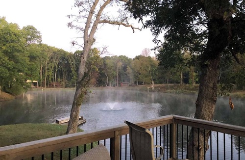 Collinsville House | Escape to a private 3BR waterfront retreat on a 7-acre pond near Route 66. Enjoy peaceful views, a fire pit with seating, fishing dock, and spacious living areas. Perfect for relaxing getaways with easy access to St. Louis attractions.