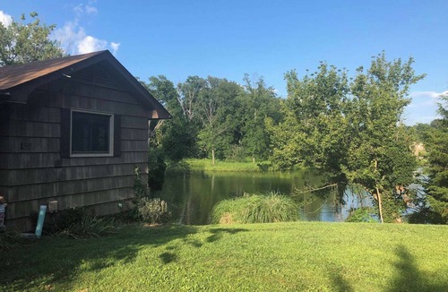 Collinsville House | Escape to a private 3BR waterfront retreat on a 7-acre pond near Route 66. Enjoy peaceful views, a fire pit with seating, fishing dock, and spacious living areas. Perfect for relaxing getaways with easy access to St. Louis attractions.