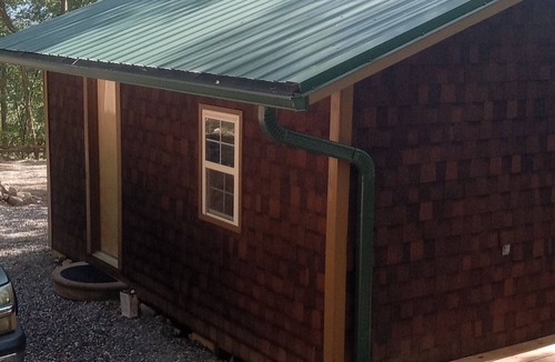 Mena Cabin | HICKORY HIDEOUT The cabin is surrounded by a large area of trees for privacy