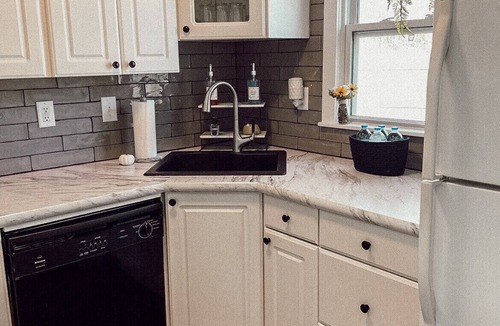 Liberty Cottage | Near Kansas City area cottage with a fire pit! Comfy beds and a stocked kitchen.