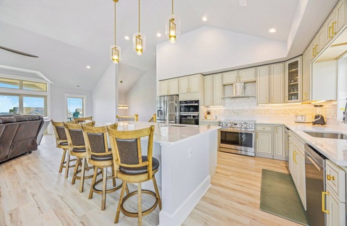 Wind Over Waves House | New Soundside Dog Friendly Avon Retreat with Pool, Hot Tub, Game Room, Theater