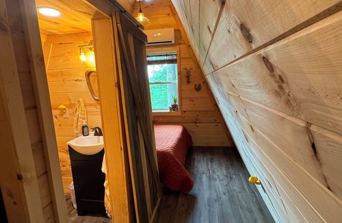 Corbin Cabin | The Naturalists is a peaceful off grid A frame cabin with an outdoor shower.