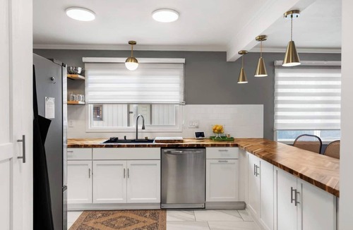Kansas City House | Upscale comfort near Legends, KC Speedway & Sporting KC stadium. Chef's kitchen, private hot tub, & google fiber.