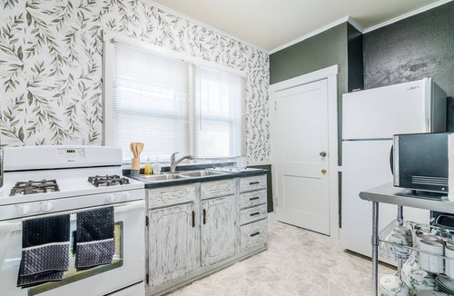 Manhattan House | Walk To Aggieville from Brick Cottage with Man Cave, Shuffle Board, Back Yard